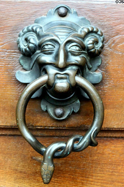 Cast metal door pull with horns & snake at Gößweinstein pilgrimage basilica. Gößweinstein, Germany.