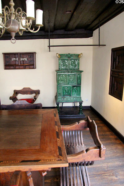 X-chair (aka Savonarola chair) beside inlaid table with tile stove beyond at Albrecht Dürer's House. Nuremberg, Germany.