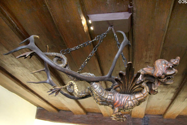 Side view of Lusterweibchen dragon chandelier upon reindeer antlers, sculpted by Veit Stoss after design by Albrecht Dürer at Albrecht Dürer's House. Nuremberg, Germany.