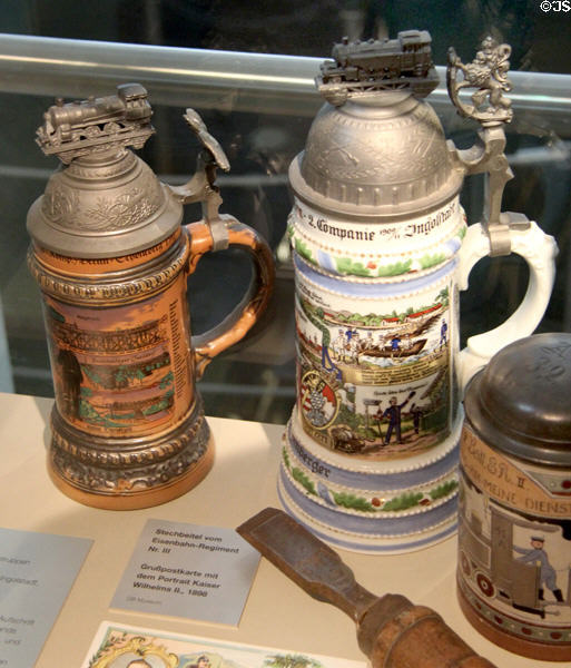 Beer steins of three railway army reserve regiments (1906-11) topped by model locomotives at Nuremberg Transport Museum. Nuremberg, Germany.