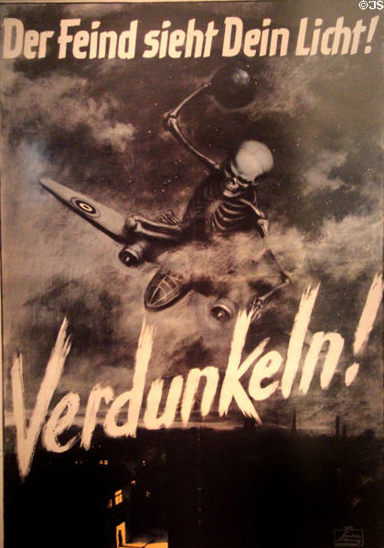 Blackout poster of death on a British bomber with slogan "the enemy sees your light! Darken!" at Nuremberg Transport Museum. Nuremberg, Germany.