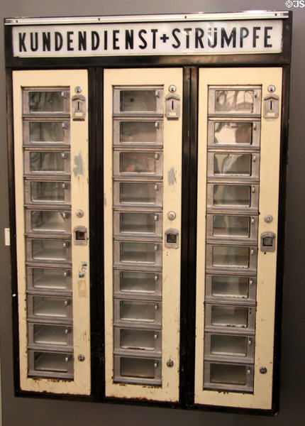 Antique customer self-service coin vending machine for stockings from rail station at Nuremberg Transport Museum. Nuremberg, Germany.