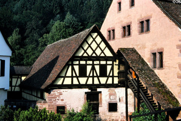 Traditional building with steep roof, wood framing & covered stairs leading to upper floor. Hirsau, Germany.