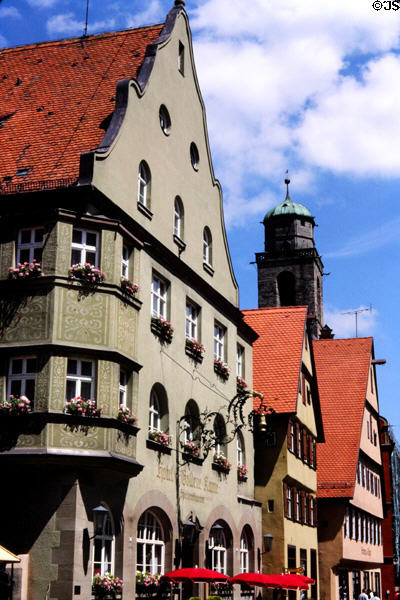 Hotel in historic center with ornate wrought iron sign & bell on front facade. Dinkelsbühl, Germany.
