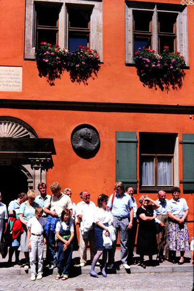 Locals enjoy festivities in front of historic building occupied in 1632 by Swedish King Gustavus Adolphus during Thirty Years War. Dinkelsbühl, Germany.