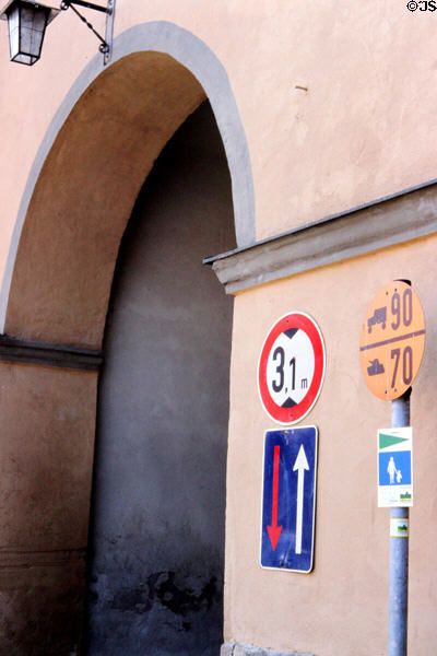 Sign warning of very narrow & low passage through city walls & sign indicating speed limits for military tanks & trucks. Dinkelsbühl, Germany.
