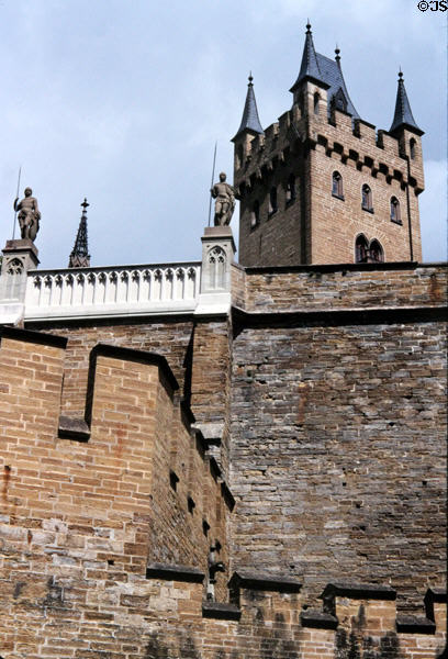 Walls guarded by statues of knights & tower of Hohenzollern Castle. Germany.