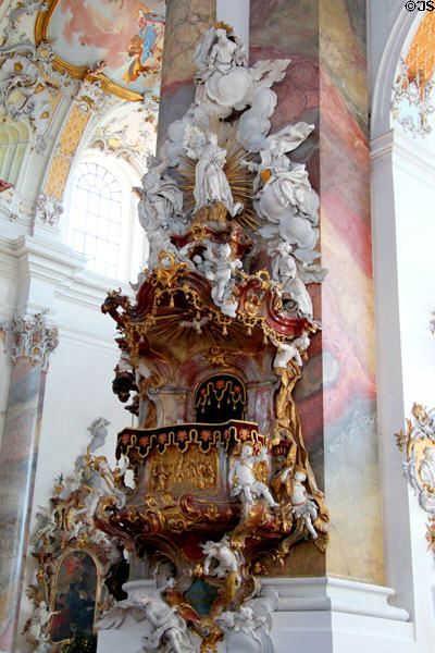 Baroque pulpit overlooked by sunburst & Holy Spirit at Ottobeuren Abbey. Ottobeuren, Germany.