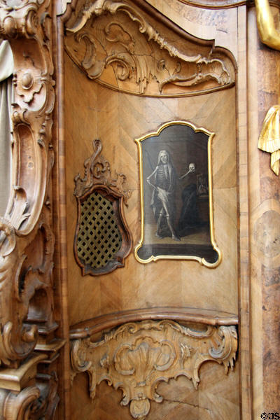 Detail of confessional with painting of skeleton holding skull at Ettal Benedictine Abbey. Ettal village, Germany.