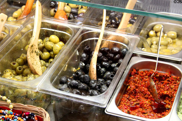 Olives and other condiments for sale on display in shop. Füssen, Germany.