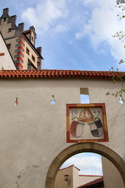 Bishop's symbol, dated 1899, over archway to Hohes Schloss zu Füssen. Füssen, Germany.