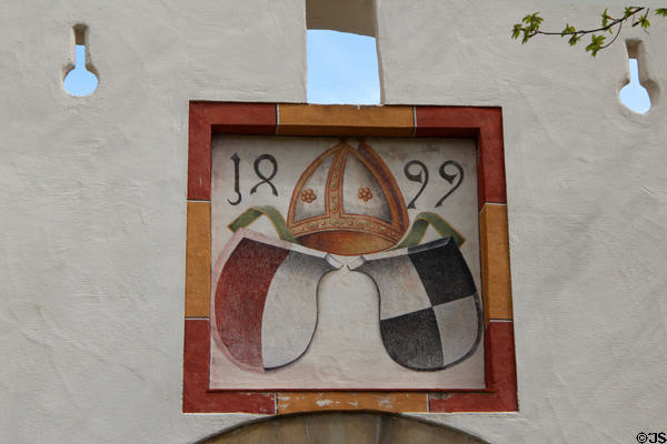 Bishop's symbol, dated 1899, over archway to Hohes Schloss zu Füssen. Füssen, Germany.