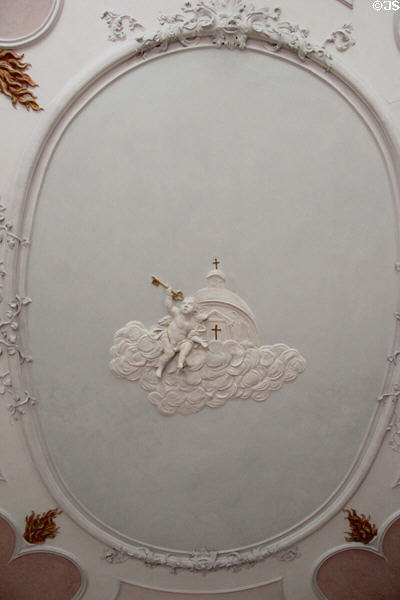 Plaster work of a cloud with church & angel holding the Keys to the Kingdom at Basilica St Mang. Füssen, Germany.