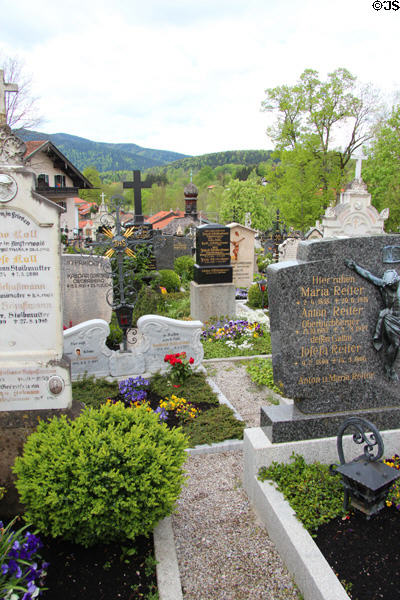 Cemetery of St Aegidius parish church with hills in background. Gmund am Tegernsee, Germany.