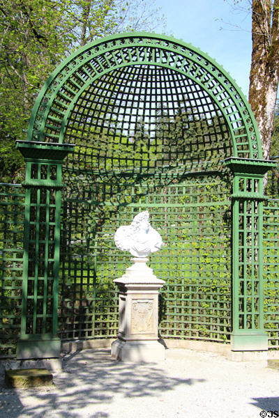 Niche-like pergola section in which statue is placed in formal garden at Linderhof Castle. Ettal, Germany.