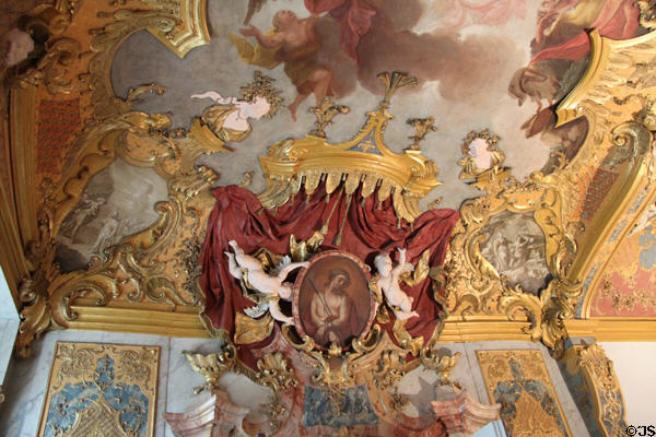 Framed Passion of Christ painting, held by cherubs, by Franz Georg Hermann at Kempten Residenz. Kempten, Germany.