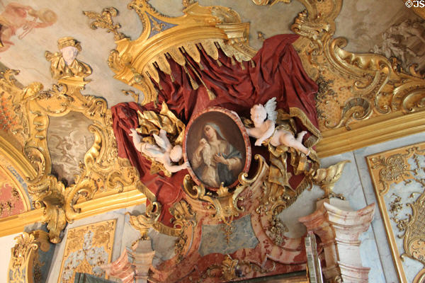 Oval framed painting, held by cherubs, of devout woman by Franz Georg Hermann at Kempten Residenz. Kempten, Germany.