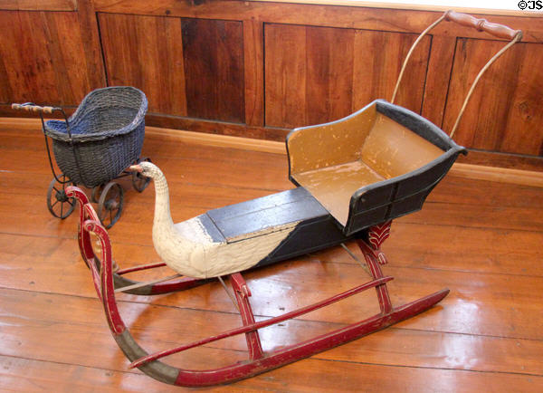German child's snow sleigh & toy baby carriage at Lindau Municipal Museum. Lindau im Bodensee, Germany.