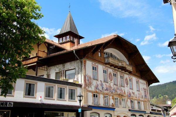 Traditional building with overhanging roof, wooden balcony & frescoes on facade. Oberammergau, Germany.