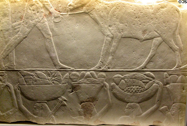 Egyptian relief (3rdC BCE) depicting man sacrificing bull & people carrying baskets of bread at Museum of Bread and Art. Ulm, Germany.