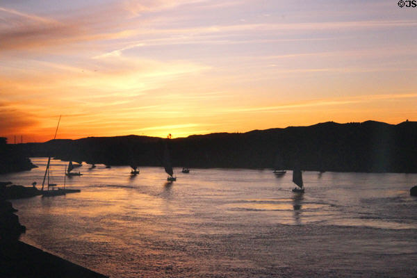 Traditional Felucca sailboats against sunset on Nile River at Aswan. Egypt.