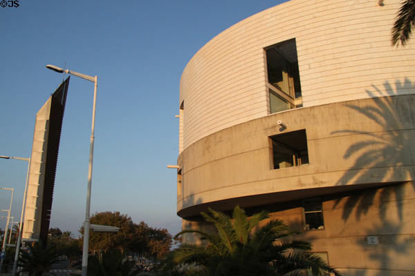 Round Meteorological Center (1992) on Avinguda Litoral with one of a series of beachfront spires beyond. Barcelona, Spain. Architect: Álvaro Siza.