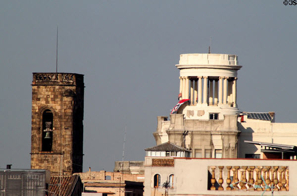 Temple structure atop building at Via Laietana & Carrer de l'Argenteria with bell tower beyond. Barcelona, Spain.
