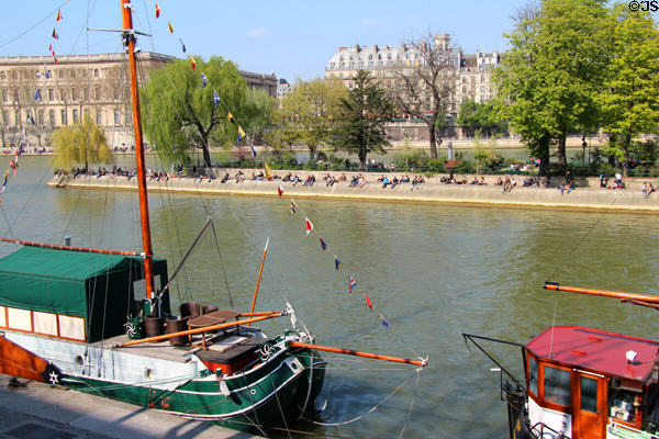Western tip of Île de la Cité beyond moored sailboats on Seine. Paris, France.