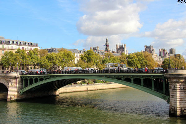 Pont Notre-Dame (1914) iron arch bridge with city hall towers beyond. Paris, France.