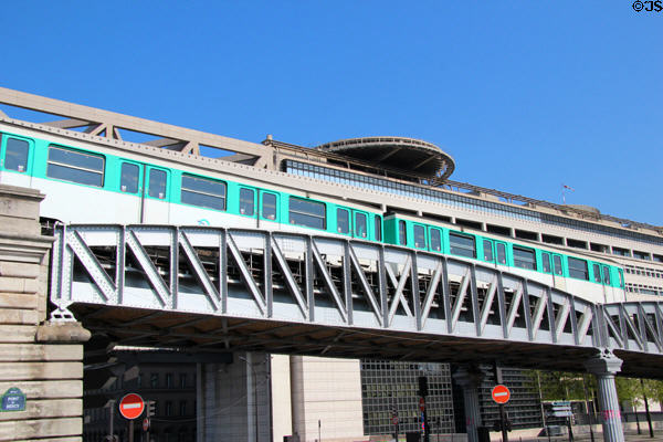 Metro train on Bercy bridge in front of Embarcadère du Ministère des Finances. Paris, France.