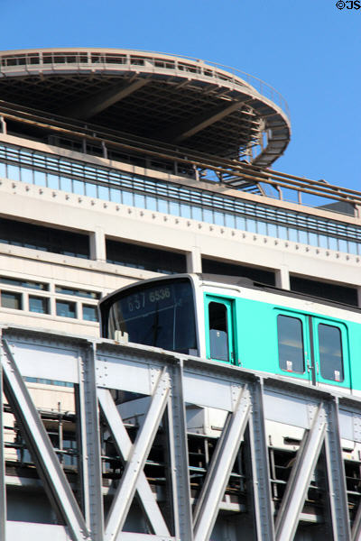 Metro train on Bercy bridge in front of Embarcadère du Ministère des Finances. Paris, France.