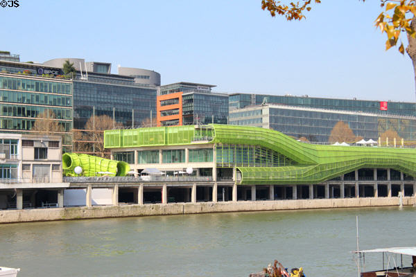 Buildings along Quai d'Austerlitz with green tubing facade on River Seine. Paris, France.
