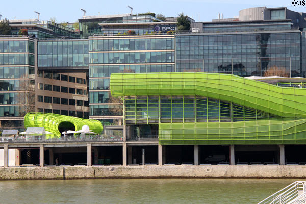 Buildings along Quai d'Austerlitz with green tubing facade on River Seine. Paris, France.