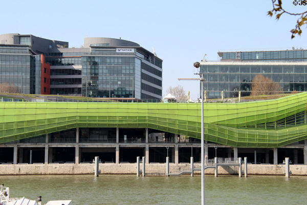 Buildings along Quai d'Austerlitz with green tubing facade on River Seine. Paris, France.