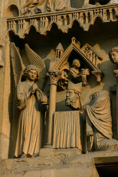 Statue of St Denis patron saint of France on Cathedral. Reims, France.