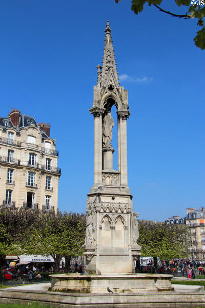 Gothic fountain of the Virgin behind Notre Dame Cathedral. Paris, France.
