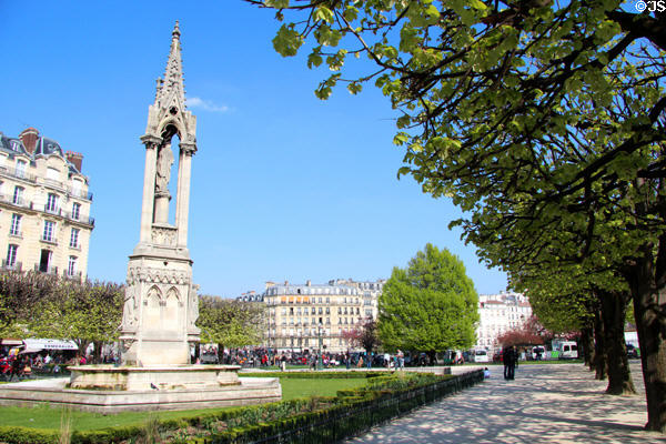 Gothic fountain of the Virgin behind Notre Dame Cathedral. Paris, France.