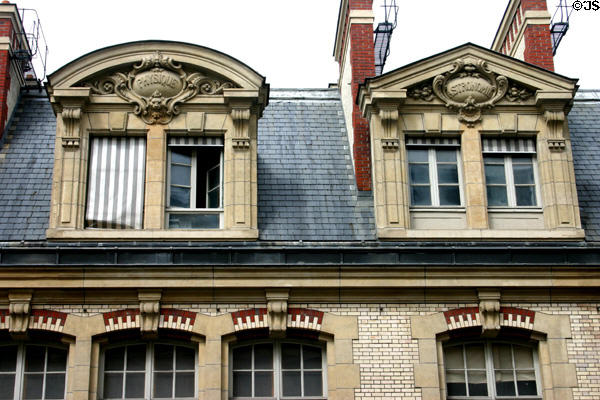 Pediment facade details with scientific discipline plaques on rue St-Jacques at Sorbonne University. Paris, France.