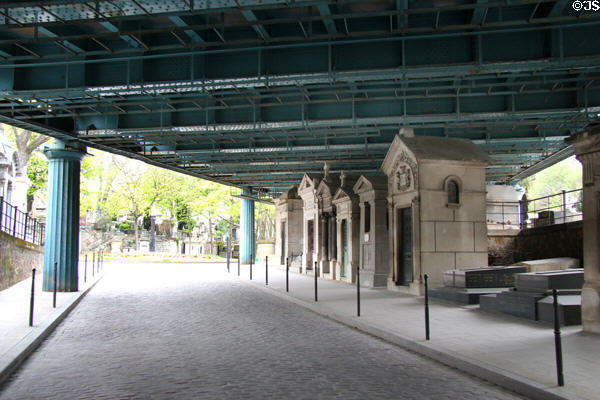 Roadway overpass bridge over tombs at Montmartre Cemetery. Paris, France.