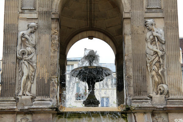 Detail of nymphs pouring water on Fountain of the Innocents along rue Berger. Paris, France.