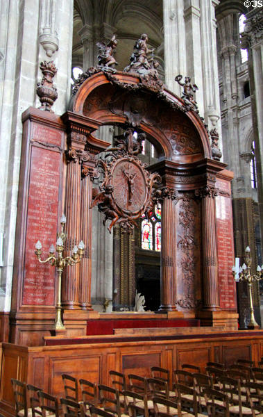 Carved wooden arch with names of past priests at St Eustache Les Halles. Paris, France.