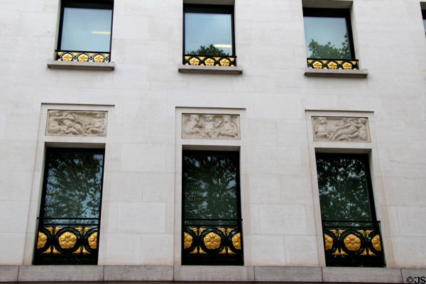 Building with golden railings on windows at 23 Champs Elysees. Paris, France.