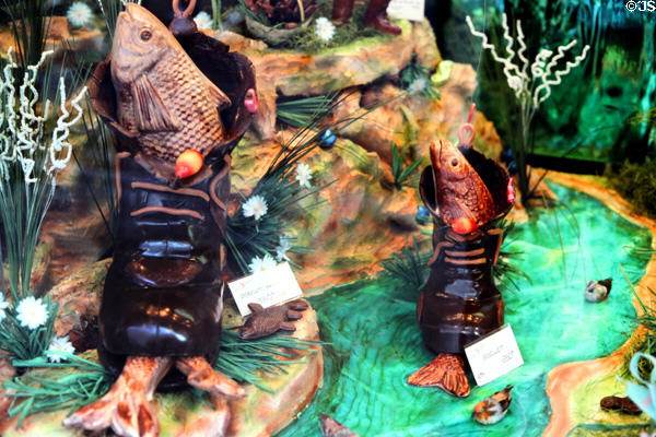 Molded chocolate fish in chocolate boots in sweets shop. Paris, France.
