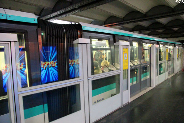 Paris metro station with elevator-like safety doors which open with doors on train. Paris, France.
