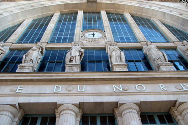 Symbolic statues of destination cities over entrance of Gare du Nord. Paris, France.