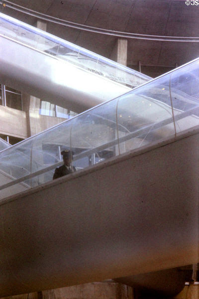 Criss-crossed escalators in terminal at Charles-de-Gaulle Airport. Paris, France.
