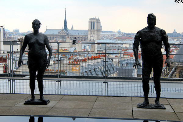 Sculpture group on upper deck at Georges Pompidou Center with Notre Dame cathedral beyond. Paris, France.