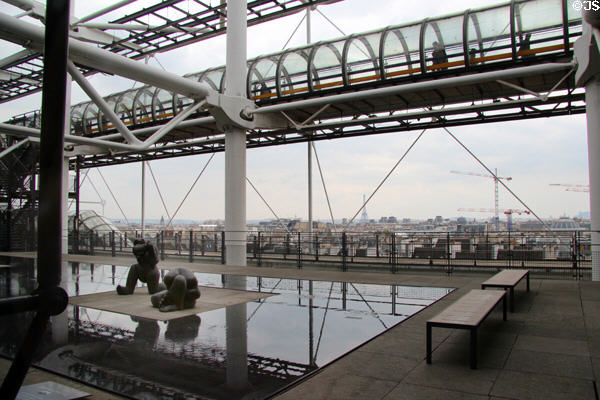 Sculptures on external pool on upper deck with glass tunnel walkway at Georges Pompidou Center. Paris, France.