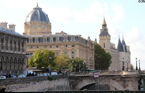 Domed Court of Commerce (1860-5) & Conciergerie (14thC) with multiple towers on Ile de la Cité as viewed from Seine River. Paris, France.