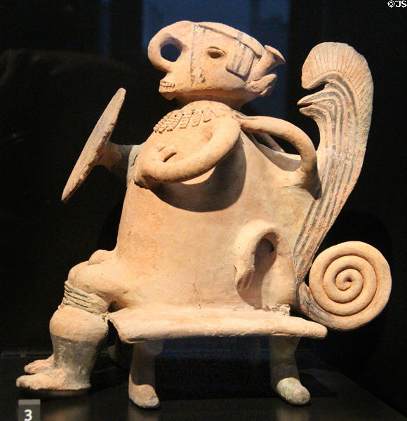 Cauca culture terra cotta statuette of warrior sitting on chair (1000 - 1600) from Colombia at Musée du quai Branly. Paris, France.